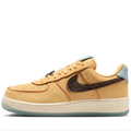 Nike Golden Tan Low-Top Sneakers with Dark Brown Swoosh and Pale Blue Accents